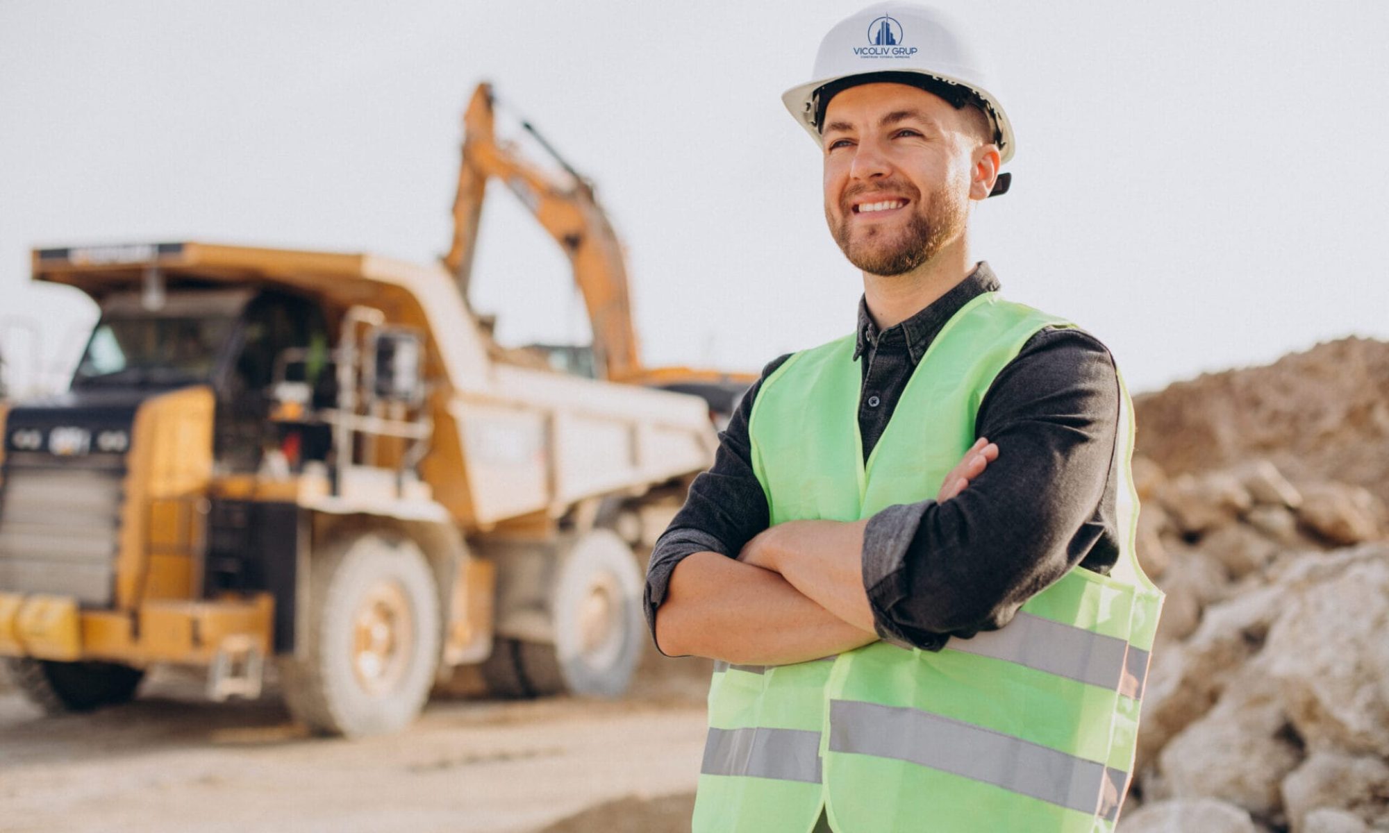 Male worker with bulldozer in sand quarry